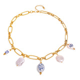 Gold necklace with various charms on a white background